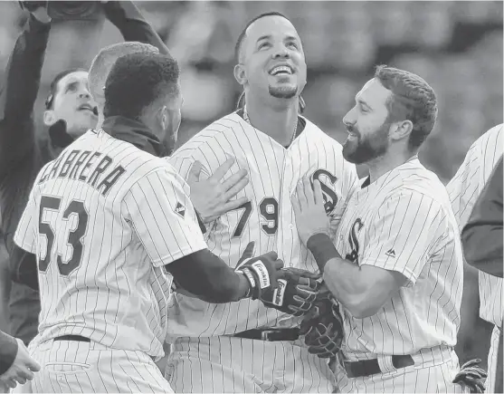  ?? | DAVID BANKS/AP ?? White Sox first baseman Jose Abreu (79) celebrates his game-winning single with Melky Cabrera (left) and Adam Eaton on Saturday at U.S. Cellular Field.