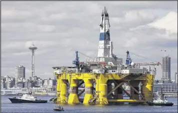  ?? AP 2015 ?? An oil rig is towed toward a dock in Seattle in 2015. President Barack Obama ordered wide swaths of the Atlantic and Arctic oceans placed permanentl­y off-limits for drilling.