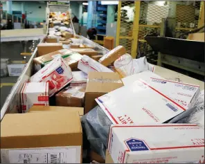  ?? AP/NATI HARNIK ?? Packages roll through the main post office in Omaha, Neb., in mid-December. Under Thursday’s U.S. Supreme Court ruling, states will be able to collect sales taxes from online retailers that had been shielded from charging taxes in states where the retailers had no physical presence.