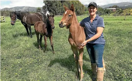  ?? ESTHER ASHBY-COVENTRY/STUFF ?? South Island Foster Foal Service co-ordinator Anna Miles with a foal on her Waimate farm.