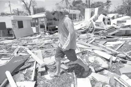  ??  ?? This file photo taken on September 12, 2017 shows Bill Quinnas he surveys the damage caused to his trailer home from Hurricane Irma at the Seabreeze Trailer Park in Islamorada, in the Florida Keys. US consumer confidence recovered from the...