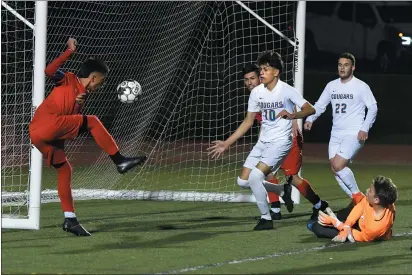  ?? CHRIS RILEY — TIMES-HERALD ?? Vallejo High’s Christian Bernal kicks the ball into an open net Saturday during the Redhawks’ 3-1loss to Newark in the North Coast Section Division II quarterfin­als.