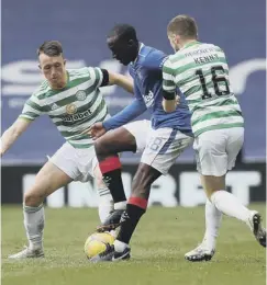  ??  ?? Glen Kamara battles for the ball with David Turnbull and Kenny