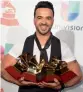  ?? — AFP ?? Singer- songwriter Luis Fonsi poses with his trophies.