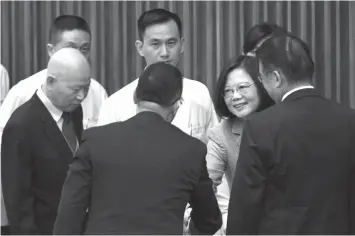  ?? AGENCE FRANCE PRESSE ?? Taiwan's President Tsai Ing-wen (right) shakes hands with a guest beside former chairman of the Democratic Progressiv­e Party (DPP) Hsu Hsin-liang (left) during a conference between Taiwan and China relations organized by Taiwan’s Mainland Affairs...