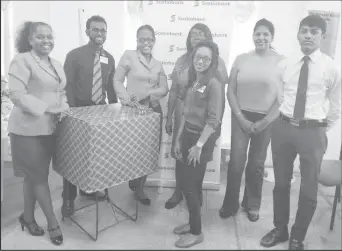  ??  ?? Help and Shelter Directors Niveta Deen and Linda Hustler (second and third from right respective­ly) are all smiles as they accept the donation from Scotiabank staff.