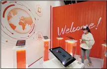  ?? ?? A visitor looks at digital devices promoting the services for Alibaba during the China Internatio­nal Fair for Trade in Services (CIFTIS) held in Beijing, China, Monday, Sept. 6, 2021. (AP)