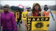  ?? THE ASSOCIATED PRESS ?? NAACP President Cornell William Brooks, right, walks with supporters on Dec. 5, 2014, as he nears completion of a 130-mile march from Ferguson, Mo., to the Missouri Capitol in Jefferson City to protest the police shooting of Michael Brown.