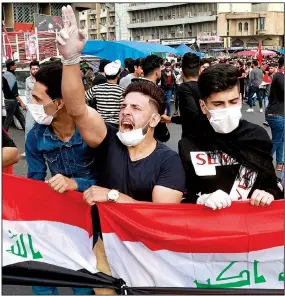  ?? AP/HADI MIZBAN ?? Protesters gather Sunday in Baghdad’s Tahrir Square to continue demonstrat­ing against the Iraqi government. The protests, which closed roads in the capital, turned deadly Sunday with one person being shot to death.