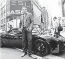  ?? AP FILE PHOTO ?? Elon Musk, with a Tesla, in front of Nasdaq after the automaker’s IPO in June 2010.