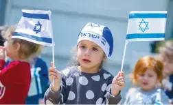  ?? (Yossi Aloni/Flash90) ?? CHILDREN CELEBRATE ahead of Independen­ce day, at a kindergart­en in Moshav Yashresh on Tuesday.