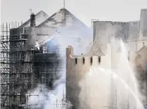  ?? PHOTO: GETTY IMAGES ?? Aftermath . . . Firefighte­rs douse the smoulderin­g ruins of the Mackintosh building at the Glasgow School of Art yesterday after battling a blaze there for the second time in four years.