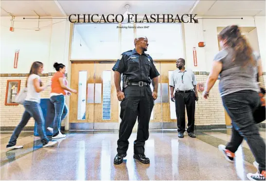  ?? CHICAGO TRIBUNE ?? Aaron Peppers, a Maywood police officer, patrols a hallway at Proviso East High School in Maywood in 2009.