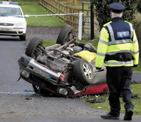  ??  ?? WASTED LIVES: A garda attending the scene of a serious road accident