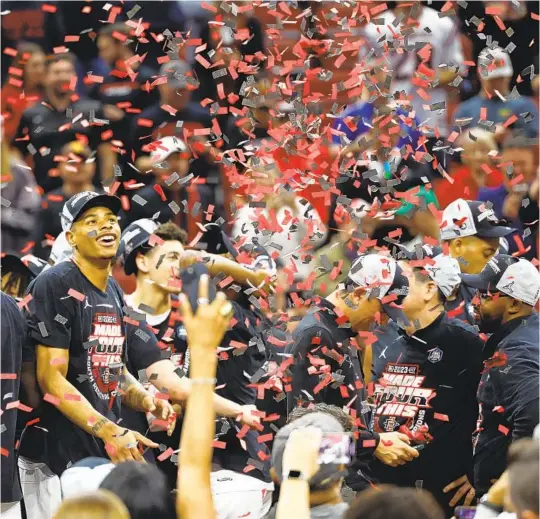  ?? K.C. ALFRED U-T PHOTOS ?? Aztecs’ Keshad Johnson watches confetti fall as he celebrates with teammates after beating Creighton 57-56 in the Elite Eight to advance to Final Four in Houston.