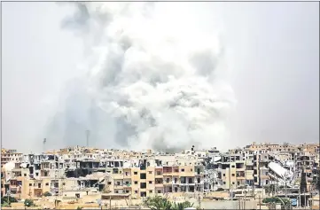  ??  ?? Smoke billows out from Raqa following a coalition air strike. Syrian government troops entered the last Islamic State group stronghold in the country’s Homs province after jihadists began withdrawin­g, a monitor said. — AFP photo