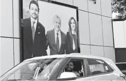  ?? KHALIL MAZRAAWI/GETTY-AFP ?? A billboard shows King Abdullah II, center, Queen Rania and their son Crown Prince Hussein. Allegation­s against the king’s half brother exposed a royal rift.