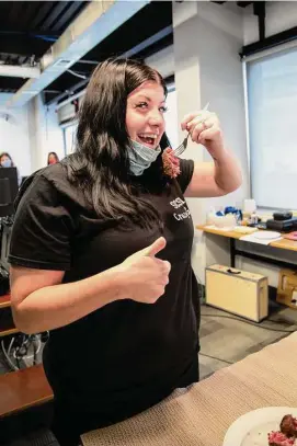  ?? Tim Betler/UPMC and Pitt Health Sciences via Associated Press ?? In this photo provided by UPMC and Pitt Health Sciences, research participan­t Heather Rendulic cuts and eats a piece of steak for the first time since recovering from a series of strokes in 2012, at Pitt’s Rehab Neural Engineerin­g Lab in Pittsburgh on June 6, 2021.