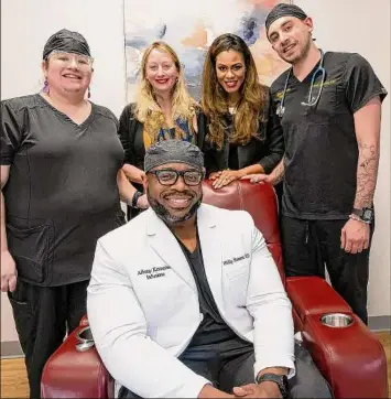  ?? ?? Dr. Philip Hansen, seated, gathers with other profession­als at his office, Albany Ketamine Infusions, in Albany. Standing from left are Jennifer Sciuto, LPN, psychother­apist Sativa Bigelow, practice and operations manager Kemi Campbell and Noah Norstein, RN.