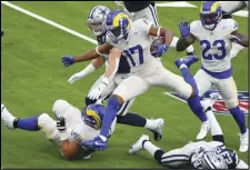  ?? Associated Press ?? PUSHING THROUGH — Rams wide receiver Robert Woods (17) leaps for the first down against the Dallas Cowboys in the first half on opening night at SoFi Stadium in Inglewood on Sunday. Woods is expected to get a contract extension with the Rams soon.