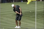  ?? CHRIS O’MEARA - THE ASSOCIATED PRESS ?? Brooks Koepka hits to the 16th green during a practice round for The Players Championsh­ip golf tournament Wednesday, March 11, 2020, in Ponte Vedra Beach, Fla.