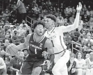  ?? MARTA LAVANDIER/AP ?? Virginia forward Jayden Gardner drives to the basket as Miami guard Jordan Miller defends during Saturday’s game in Coral Gables, Florida.