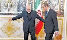  ?? VAHID SALEMI/AP ?? Iran’s Mohammad Javad Zarif, left, greets Cornel Feruta of the Internatio­nal Atomic Energy Agency on Sunday.