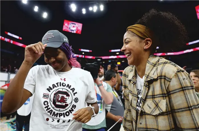  ?? ELSA/GETTY IMAGES ?? South Carolina forward/center Aliyah Boston shares a laugh with Parker, who was in the stands when the Gamecocks defeated UConn for the NCAA women’s championsh­ip on April 3 in Minneapoli­s.