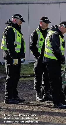  ?? ?? Lowdown: Police check drains near the Glasgow summit venue yesterday