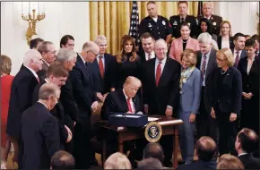  ?? OLIVIER DOULIERY/ABACA PRESS ?? U.S. President Donald Trump signs a bipartisan legislatio­n to confront the opioid crisis in the East Room of the White House on Wednesday in Washington, D.C.