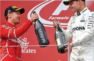  ?? REUTERS ?? Cheers: Vettel, left, congratula­tes Austrian GP winner Bottas