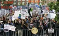  ?? TED S. WARREN - THE ASSOCIATED PRESS ?? Counter-protestors stand behind barricades across the street from an anti-Islamic law protest rally Saturday, in Seattle. Rallies against Islamic law have drawn larger counter-rallies in some U.S. cities. Hundreds of counter-protesters marched through...