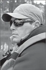  ?? Arkansas Democrat-Gazette/BRYAN HENDRICKS ?? Rick Ellis scans the surface of Lake Maumelle before deploying his subsurface “eyes,” a Lowrance HDS9 graph that helps him scan the bottom for fish-holding structure.