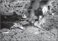  ?? AP/WLBT-TV ?? Smoke and flames rise from a military plane that crashed Monday in a farm field in Itta Bena, Miss.