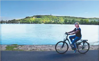  ?? GLACIER MEDIA PHOTO BY STEVE MACNAULL ?? Guide Claudia Lewerenz, above, cycles along the River Rhine. Sophie Egert, below, is one of Rheingau’s wine princesses.