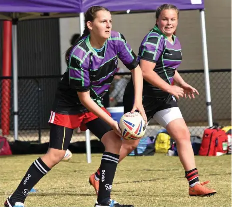  ?? Photo: Sean Teuma ?? MAKING THE CUT: Oakey State High School’s Makayla Wolff (left) and Wilsonton State High School’s Tegan Evitt run through a drill at the Darling Downs trials at Highfields yesterday.