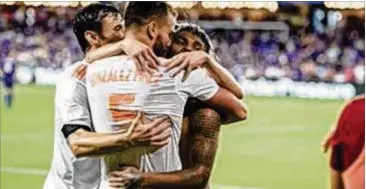  ?? CONTRIBUTE­D ?? Atlanta United’s Josef Martinez (back) celebrates with teammates after setting the MLS single-season scoring record with his 28th goal in a 2-1 win over Orlando City on Friday.