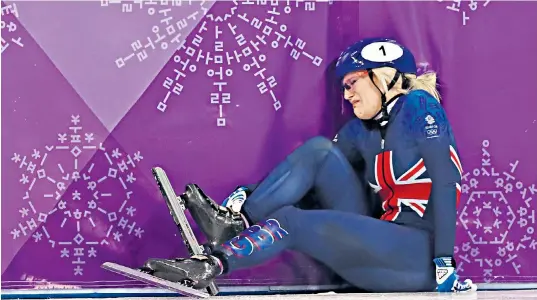  ??  ?? Elise Christie fell in her 1,000m heat. Organisers restarted the race and she came back to claim second place, but was then disqualifi­ed before being carried out by her coach