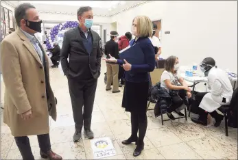  ?? Ned Gerard / Hearst Connecticu­t Media ?? Gov. Ned Lamont, center, speaks with Yale New Haven Health CEO Marna Borgstrom on Monday at a COVID-19 vaccinatio­n clinic in Bridgeport. Yale New Haven Health led all Connecticu­t employers for new job openings in the past few weeks, many of them at pay well above the state’s $78,000 average household income.