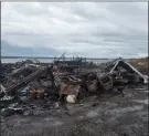  ??  ?? TheCanadia­nPress
Debris from a burnt out fish plant is scattered along the shore in Middle West Pubnico, N.S. A large fire destroyed a commercial building that was the scene of a confrontat­ion earlier in the week between Indigenous and non-Indigenous fishermen.