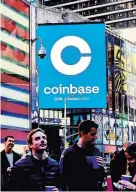  ?? GABBY JONES FOR THE NEW YORK TIMES ?? Coinbase workers gathered in Times Square in April 2021 to watch its initial public offering displayed on the Nasdaq tower.