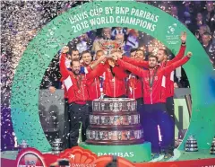  ?? AFP ?? Croatia players and officials celebrate with the Davis Cup trophy.