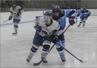  ?? LIBBY O’NEILL — BOSTON HERALD ?? St. Mary’s Vanessa Hall and Peabody’s Shirley Whitmore stare down the puck during a game at Connery Skating Rink in Lynn.