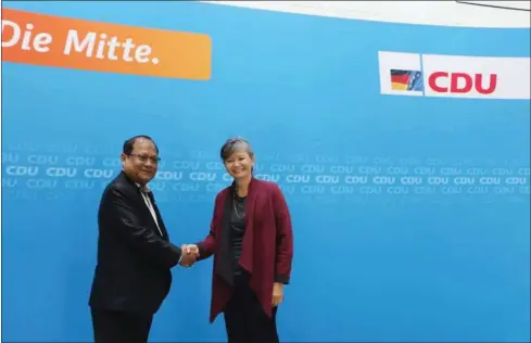  ?? PHOTO SUPPLIED ?? CPP member and Ministry of Interior spokesman Khieu Sopheak (left) shakes hands with CNRP lawmaker Mu Sochua at a workshop in Berlin hosted by NGO Konrad Adenauer Stiftung earlier this year.