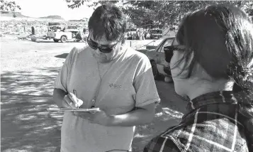  ?? Tribune News Service ?? ■ Delaney After Buffalo, right, registers Leonard Holiday to vote in Oljato, Utah. Many Native Americans face barriers when trying to vote.