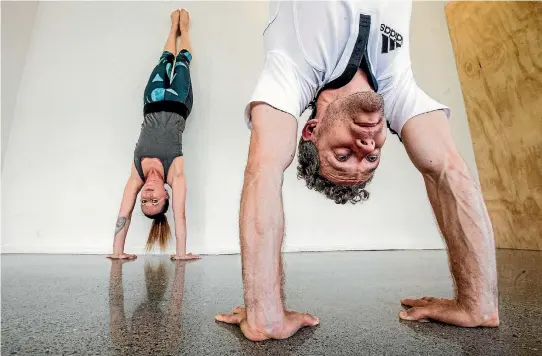  ?? PHOTO: ROBERT KITCHIN/FAIRFAX NZ ?? Aaron Burr, at Thrive Pilates in Wellington, teaching Anna Cochrane a handstand as a form of balance and exercise.