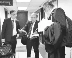  ??  ?? Ching (left) and Douglas (centre) for Shafie, and Marcel (right) for Mohd Ainal, outside the courtroom yesterday.