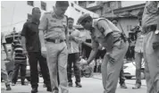  ??  ?? Assam DGP Jayanta Narayan Choudhury, along with others, inspects the blast spot in Guwahati on Monday.—