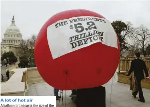  ??  ?? A lot of hot air
A balloon broadcasts the size of the deficit under President George W Bush, Washington DC, 2004. Trump, too, has faced criticism for presiding over a huge hike in the national debt