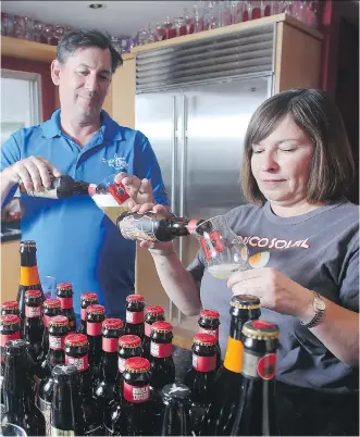  ?? TED RHODES ?? Mike Tessier and partner Bo Vitanov pour themselves beer from Trou du Diable of Shawinigan, Que. The couple runs Artisan Ales, a beer-importing company they say has been hit hard by changes in taxes imposed by the provincial government. A panel has now...